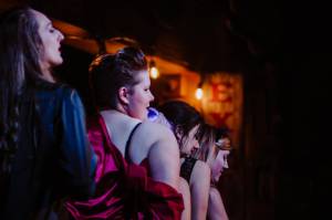 Taylor Vidic, Kelsey Riker and other performers stand in a line as they sing at a previous Nude & Rude event. Vidic said the upcoming Halloween weekend show will be the crews first performance since 2019. (Courtesy Photo/ Sydney Akagi)