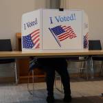 A voter sits behind a privacy screen while filling out a ballot during the City and Borough of Juneau 2022 municipal. The City and Borough of Juneau announced the final results of its 2022 local election showing a voter turnout just under 33% of all registered voters who participated in this years election.(Clarise Larson / Juneau Empire)
