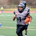 Jarrell Williams sprints down the sidelines during a dominant win against Bettye Davis East Anchorage High School on Saturday, Oct. 15. Williams, who has been a standout at defensive back and quarterback this season, will square off against Colony High School, which boasts an exceptional defender and quarterback of its own, for a Division I state title on Friday. (Ben Hohenstatt / Juneau Empire File)