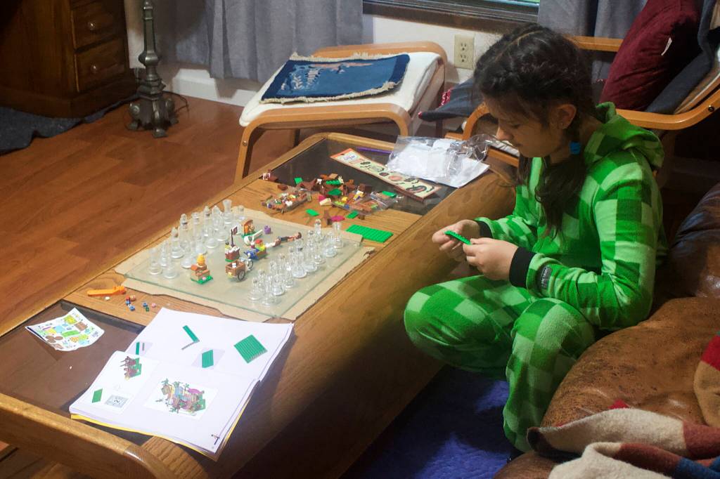 Mark Sabbatini / Juneau Empire 
Irynka Pomynalnyi, 10, plays with a chess set, Legos and other items in her familys Mendenhall Valley home on Oct. 14, about three weeks after the family arrived in Juneau after fleeing the war in their homeland Ukraine.