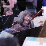 Sarah McNair-Grove laughs during a rehearsal for the upcoming Juneau Community Bands concert. The performance will include screening a short film depicting Godzilla destroying Las Vegas. (Ben Hohenstatt / Juneau Empire)