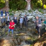Those gathered on the beach at Anan Creek, joined in song with Virginia Oliver leading on drum, were among the 42 people from the conference who joined the tour of the cultural sites there, led by archeologists of the U.S. Forest Service. (Peter Metcalfe / Sharing Our Knowledge Conference)