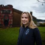 Mia, the author, stands in front of the Chief Shakes Clan House in Wrangell. Photo by Bethany Sonsini Goodrich, Sustainable Southeast Partnership.