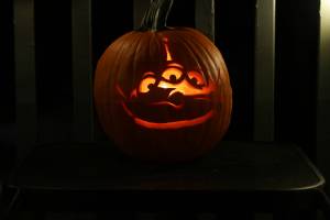 A jack-o'-lantern carved to depict an alien from "Toy Story" rests outside a Mendenhall Valley residence. (Ben Hohenstatt / Juneau Empire)