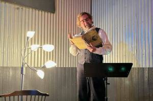 Michael Christenson, Juneau resident and producer of Moonlit Poets, reads his poetry at Moonlit Poets soft opening event hosted in early September. The poetry group is set to kick off its grand monthly entrance in downtown Juneau at the Crystal Saloons back room this Friday night. (Courtesy Photo / Summer Koester)