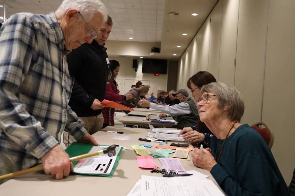 Clarise Larson / Juneau Empire
A participant at the reentry simulation asks for spare passes after using up all of his. The group of around 30 people who participated and simulated the life of a person reentering society used fake money, bus passes and items to pawn during the hour-long activity in an attempt to understand the burdens and difficulties that many people face as soon as they are released.