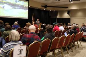 Participants sit in jail Wednesday afternoon at a reentry simulation at Elizabeth Peratrovich Hall hosted by the Juneau Reentry Coalition. (Clarise Larson / Juneau Empire)