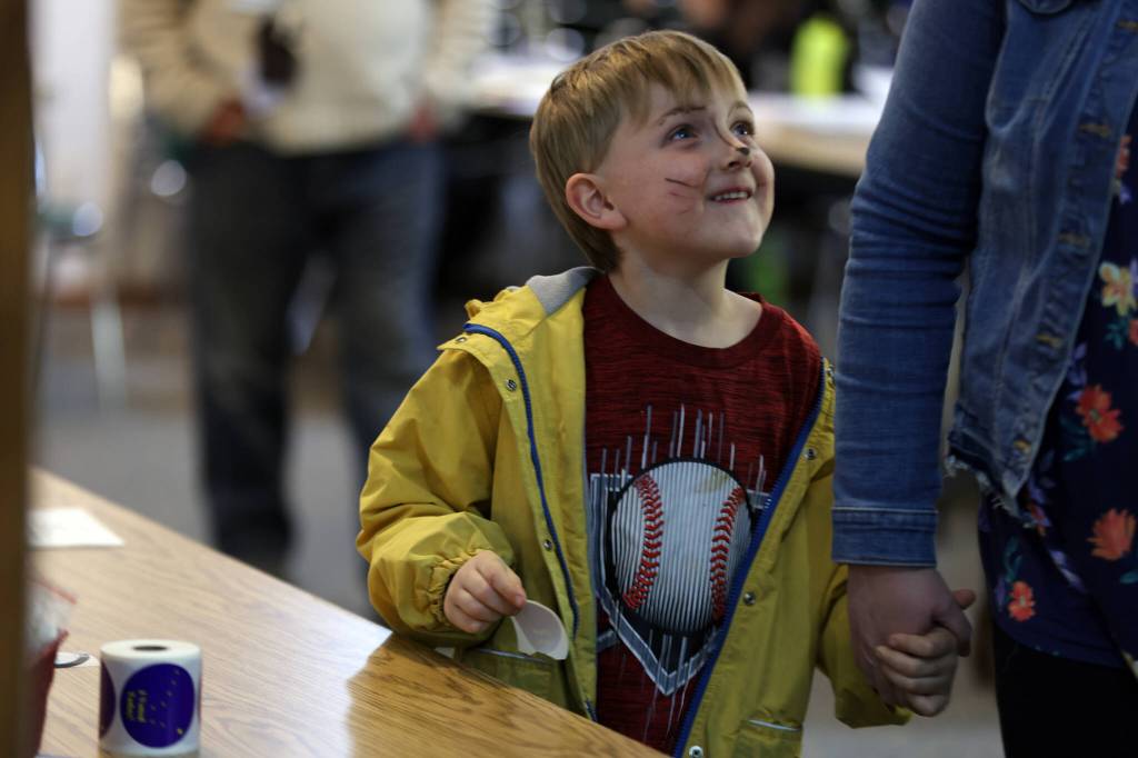 Rook Anderson, 5, beams after collecting an I Voted sticker at Shepherd of the Valley Lutheran Church on Tuesday evening. (Ben Hohenstatt / Juneau Empire)