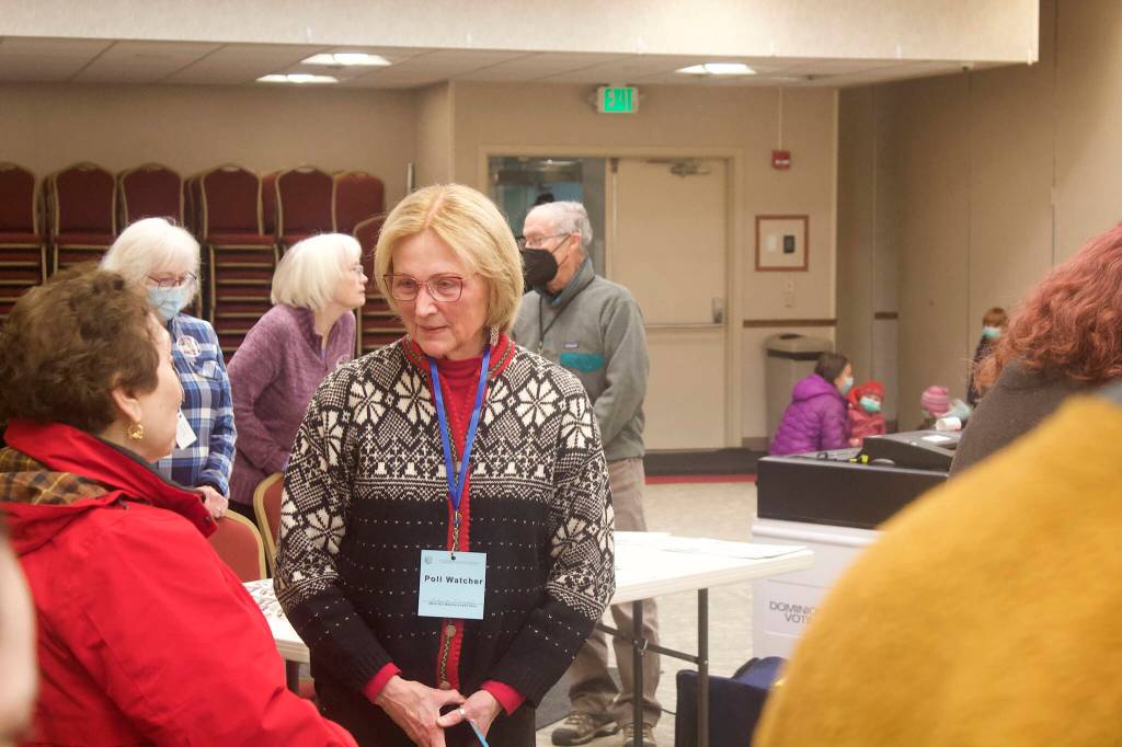 Mark Sabbatini / Juneau Empire 
Brenda Knapp, an official poll watcher at the Elizabeth Peratrovich Hall polling station, chats with a voter late Tuesday morning. While some election workers and voters nationwide have reported being threatened by observers, Knapp said part of her role is to watch for and report troublemakers.