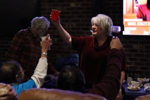 Claire Richardson, director of constituent services for U.S. Rep. Mary Peltola, offers a toast at a watch party McGivney’s Sports Bar & Grill as the incumbent emerges with a strong lead on Election Night. But Richardson said the state’s new ranked choice voting makes it likely the winner won’t be known until second- and third-choice ballots are tallied Nov. 23. (Mark Sabbatini / Juneau Empire)