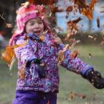 KinderReady Preschool student Isla Taintor throws leaves in the air on a cold Tuesday morning. Taintor and her KinderReady Preschool class from Harborview Elementary joined in on the fun at the annual student leaf jump event organized by retired teacher Linda Torgerson. (Clarise Larson / Juneau Empire)