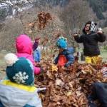 KinderReady Preschool students from Harborview Elementary frolic in a pile of dried leaves at Evergreen Cemetery on Tuesday. The leaf pile is an annual event organized by Linda Torgerson and has been happening in Juneau for around 25 years. (Clarise Larson / Juneau Empire)