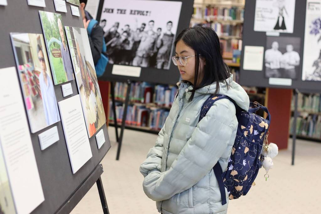 Mark Sabbatini / Juneau Empire 
Charlene Zanoria, a student at the University of Alaska Southeast, looks at part of the exhibit Waging Peace In Vietnam: The Story of U.S. Soldiers and Veterans Who Opposed the War during a preview event Thursday in the universitys library. The exhibit will officially be open from Friday through Dec. 15.