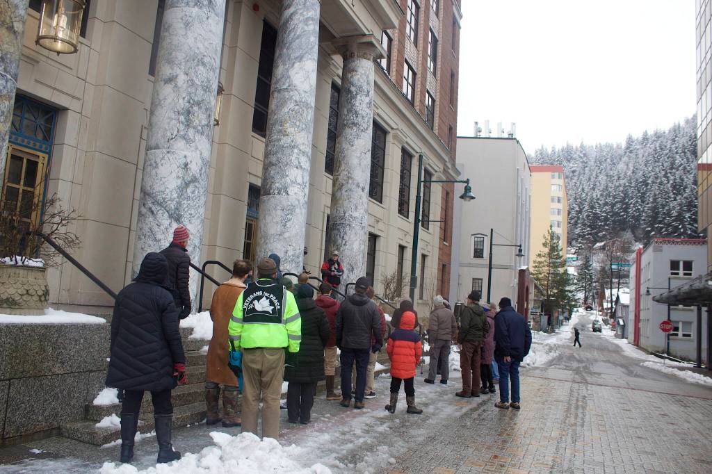About 20 veterans, family members and supporters gather outside the Alaska State Capitol on Friday morning for an annual commemoration of Armistice Day, which marked the end of World War I in 1918. The Nov. 11 date was changed to Veterans Day by President Dwight Eisenhower in 1954. (Mark Sabbatini / Juneau Empire)