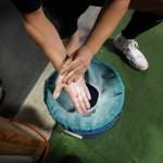 A competitor at the USA Powerlifting Coastal Clash competition adds chalk to his hand before heading to the bar to deadlift Monday. (Clarise Larson / Juneau Empire)