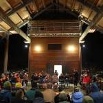 Clarise Larson / Juneau Empire 
More than 50 people sit on benches surrounding a fire pit that was used to conduct a traditional Tlingit fire dish ceremony in honor of late UAS professor Sol Neely, who died unexpectedly from a heart attack while backpacking last month.