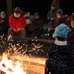 Clarise Larson / Juneau Empire 
Two young children face the flames of a fire at a celebration of life ceremony hosted at the University of Southeast Alaskas Noyes Pavilion in honor of late UAS professor Sol Neely Saturday evening.
