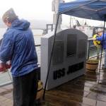 Mark Sabbatini / Juneau Empire 
Rob Smith, left, of the American Legion Auke Bay Post 25, and Dan McCrummen, quartermaster of Veterans of Foreign Wars Taku Post 5559, place wreaths Sunday on either side of a memorial for the soldiers killed aboard the USS Juneau after it was sunk by torpedoes on Nov. 13, 1942. The current memorial site for the ships namesake town debuted 10 years ago after it was relocated from its original site near Marine Park.