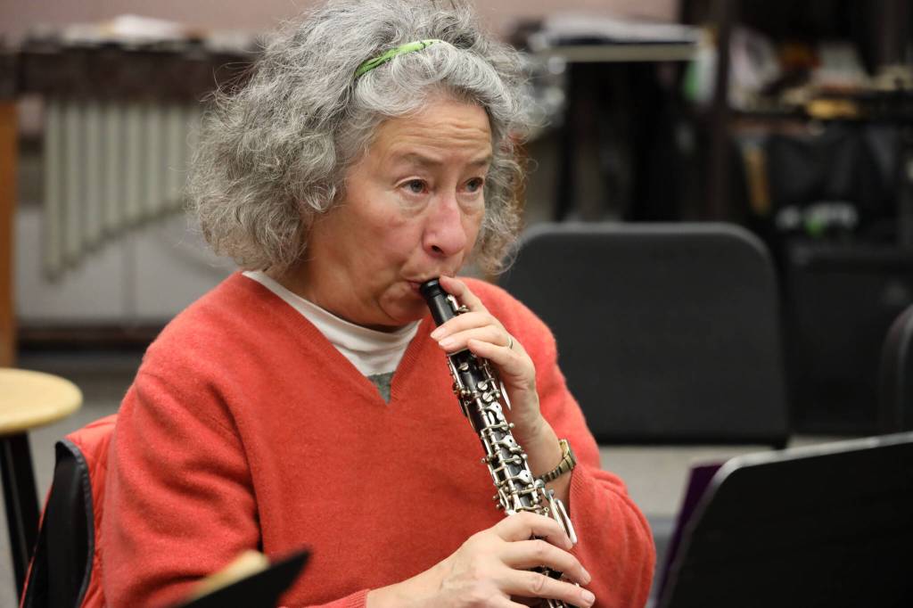 Local musician Jetta Whittaker warms up her instrument during the Con Brio Chamber Series Tuesday evening rehearsal. (Clarise Larson / Juneau Empire)