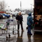 Volunteers load food for Thanksgiving food baskets into vehicles for delivery Saturday morning in the St. Vincent de Paul parking lot. (Mark Sabbatini / Juneau Empire)