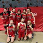 From left to right, Floyd Dryden A team members Cassie Chenoweth, Aurora Lee, Kyndal Secada, Ari Maake, Addy Hartman, Alyssa Travis, Riley Moorehouse and Riley Schultz smile for a photo. (Courtesy / Jessica Nelson)