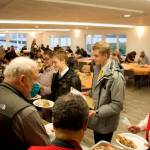 Bruce Botelho, left, and Cathy Munoz serve dinners-to-order during The Salvation Armys annual Thanksgiving meal at the Juneau Yacht Club. They were among the numerous local dignitaries volunteering for the event. (Mark Sabbatini / Juneau Empire)