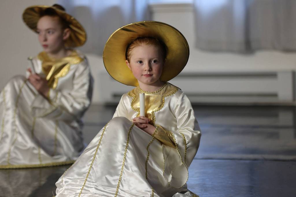 Grace Scott and Emma Rowan (background) await a visit from a fairy during rehearsal for The Nutcracker. (Ben Hohenstatt / Juneau Empire)