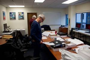 Steve Lewis, foreground, and Stephen Sorensen from the Alaska State Review Board scan ballots from precincts where they were hand counted at the Division of Elections office Nov. 15. Board officials spent the period between the Nov. 8 election and its certification Wednesday performing about 20 different to verify the results. (Mark Sabbatini / Juneau Empire)