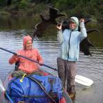 Molly Yazwinski holds a 3,000-year-old moose skull with antlers still attached, found in a river on Alaskas North Slope. Her aunt, Pam Groves, steadies an inflatable canoe. (Courtesy Photo /Dan Mann)