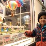 Jules Wylie-Ross smiles in front of a window display on the corner of Third and Seward streets during the downtown Business Associations Gallery Walk Friday evening. (Clarise Larson / Juneau Empire)