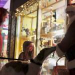 Caplan Anderson, Daphne McEwen, Romona Anderson and Rose the dog visit with Santa Claus near Nanas Attic during Gallery Walk. (Jonson Kuhn / Juneau Empire)