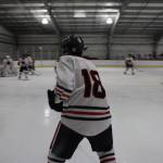 Junior Brendon West awaits a pass during a home game between Juneau-Douglas High School: Yadaa.at Kalé Crimson Bears Varsity hockey team and the Kenai Central Kardinals at the Treadwell Arena Saturday afternoon. (Clarise Larson / Juneau Empire)