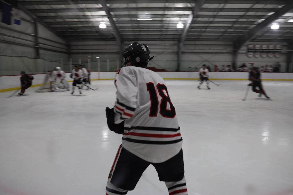 Junior Brendon West awaits a pass during a home game between Juneau-Douglas High School: Yadaa.at Kalé Crimson Bears Varsity hockey team and the Kenai Central Kardinals at the Treadwell Arena Saturday afternoon. (Clarise Larson / Juneau Empire)