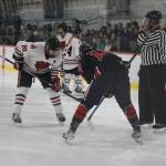 Senior and team assistant captain Brandon Campbell faces off during a home game between Juneau-Douglas High School: Yadaa.at Kalé Crimson Bears Varsity hockey team and the Kenai Central Kardinals at the Treadwell Arena Saturday afternoon. (Clarise Larson / Juneau Empire)
