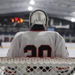 Junior Mason Sooter tends the net as the puck is in the opposite zone during a home game between Juneau-Douglas High School: Yadaa.at Kalé Crimson Bears Varsity hockey team and the Kenai Central Kardinals at the Treadwell Arena Saturday afternoon. (Clarise Larson / Juneau Empire)