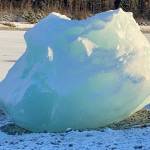 A large iceberg reflecting blue light sits in the sunshine along Mendenhall Lake. (Courtesy Photo / Denise Carroll)