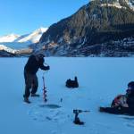 Brian Weed drills a hole on Mendenhall lake Monday morning. Weed said each winter he drills the lake around 3-4 times and has done so as a form of public service for around five years. This time around he said the average thickness was around six inches. (Courtesy / Brian Weed)