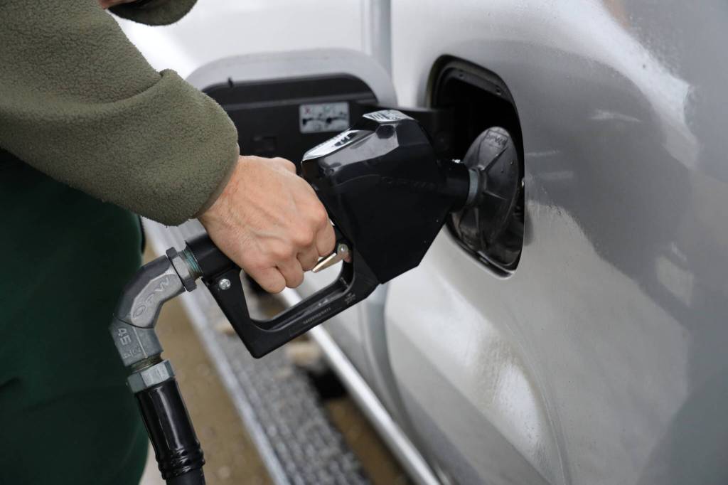Juneau resident Luke Taintor fills up his truck at the Petro One gas station off Egan Drive. (Clarise Larson / Juneau Empire)