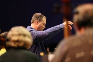 Christopher Koch, music director for the Juneau Symphony, leads the symphonys string section through rehearsal ahead of Juneau Symphonys Holiday Cheer concert. (Ben Hohenstatt / Juneau Empire)