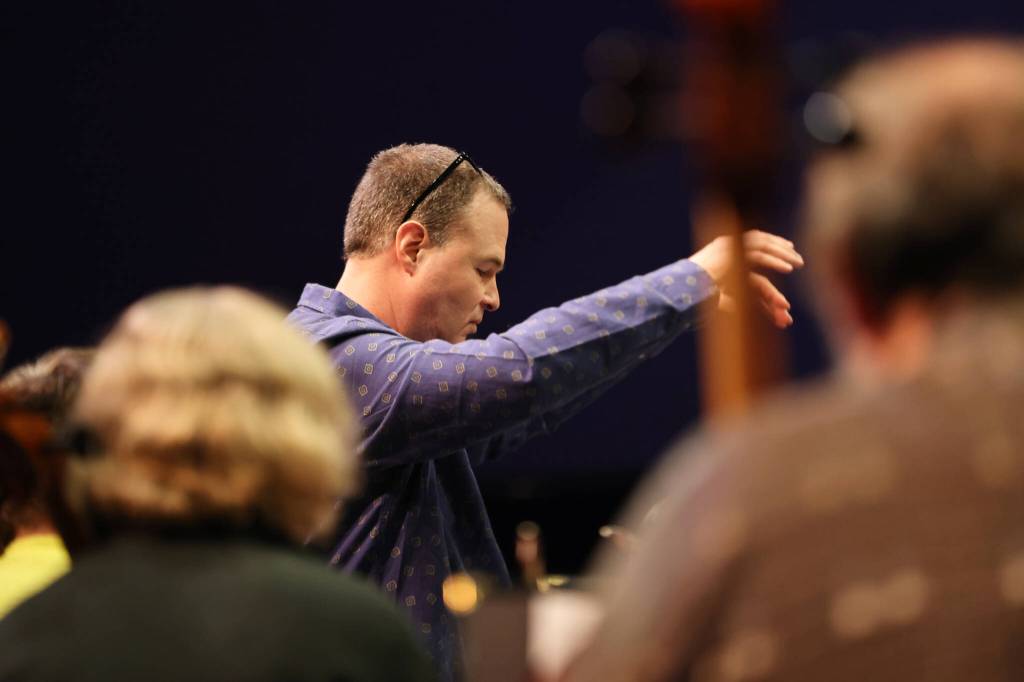Christopher Koch, music director for the Juneau Symphony, leads the symphonys string section through rehearsal ahead of Juneau Symphonys Holiday Cheer concert. (Ben Hohenstatt / Juneau Empire)