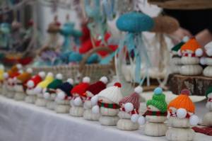 Margaret Mimnaugh with Tidal Creations from Ketchikan sets up her seasonal creations made with found hand painted sea urchin shells, along with snowmen and jelly fish at this years Stocking Stuffer Showcase on Saturday the Juneau Arts and Culture Center. (Jonson Kuhn / Juneau Empire)