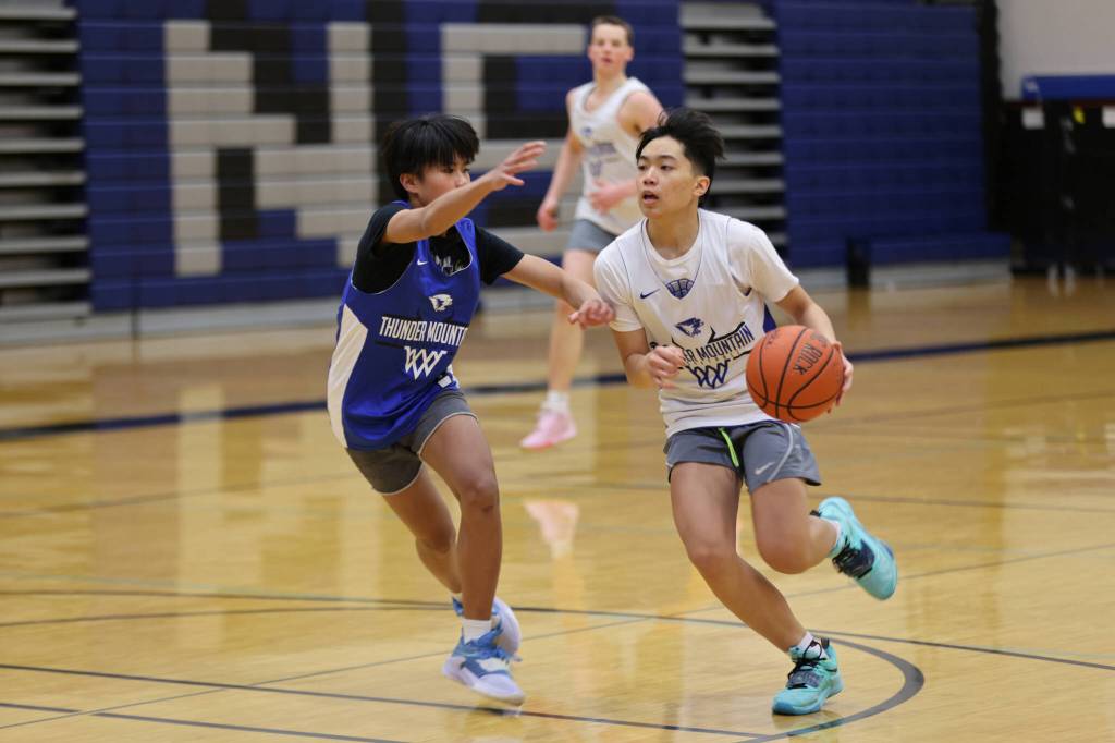 Ben Hohenstatt / Juneau Empire 
TJ Guevarra dribbles and looks to pass while defended by Jace Ribao during practice at TMHS.