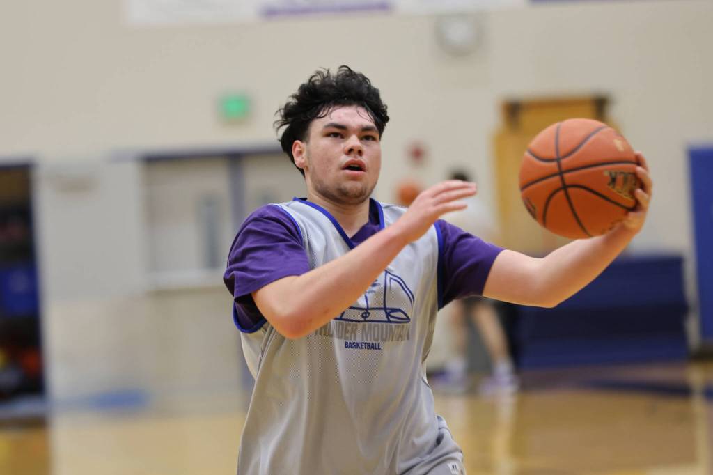Ben Hohenstatt / Juneau Empire 
MJ Tupou gathers the ball before scoring during a drill at Thunder Mountain High School. The Falcons roster includes three seniors this year.