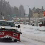 A snow plow pulls off of Glacier Highway to clear the sidewalks near a bus stop during heavy snow fall on Monday morning. (Jonson Kuhn / Juneau Empire)