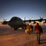 Helpers in the Alaska National Guards Operation Santa Claus board a cargo plane at Joint Base Elmendorf-Anchorage on Tuesday, Nov. 29, 2022, for a flight to Nuiqsut, Alaska. The guards outreach program attempts to bring Santa and Mrs. Claus and gifts to children in two or three Alaska Native villages each year. (AP Photo / Mark Thiessen)