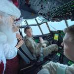 Santa and Mrs. Claus chat with the flight crew of an Alaska National Guard cargo plane while en route to Nuiqsut, Alaska, on Tuesday, Nov. 29, 2022. Operation Santa Claus, the guards outreach program, attempts to bring Santa and Mrs. Claus and gifts to children in two or three Alaska Native villages each year. (AP Photo / Mark Thiessen)