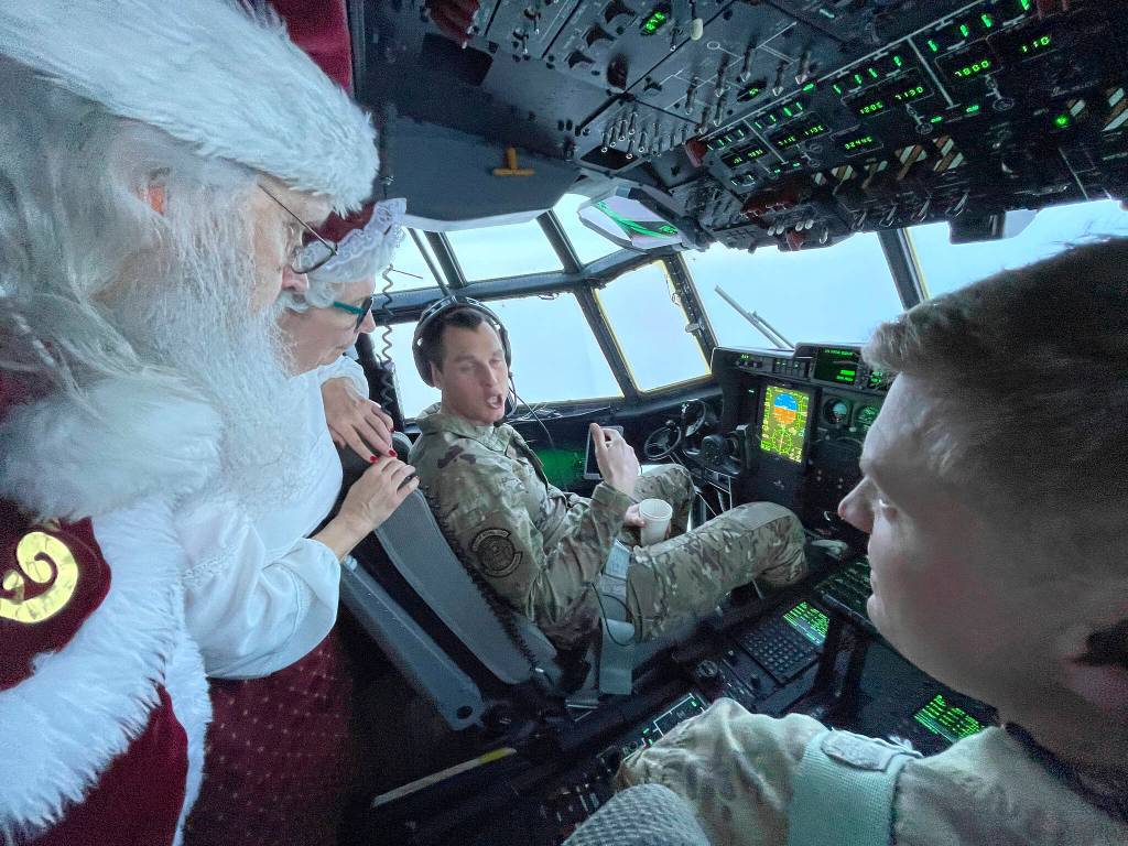 Santa and Mrs. Claus chat with the flight crew of an Alaska National Guard cargo plane while en route to Nuiqsut, Alaska, on Tuesday, Nov. 29, 2022. Operation Santa Claus, the guards outreach program, attempts to bring Santa and Mrs. Claus and gifts to children in two or three Alaska Native villages each year. (AP Photo / Mark Thiessen)