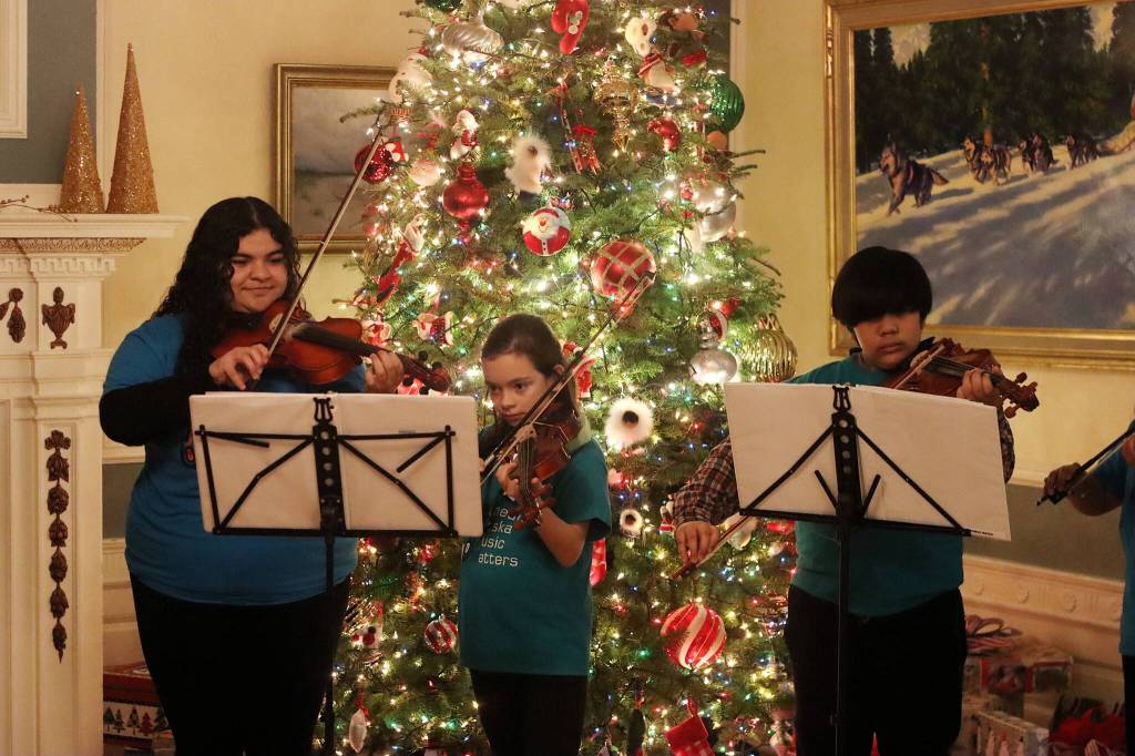 Students from the Juneau Alaska Music Matters program perform Christmas songs during the governors annual holiday open house Tuesday. (Mark Sabbatini / Juneau Empire)