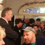 Gov. Mike Dunleavy greets visitors to the annual holiday open house at the governors mansion on Tuesday. Hundreds of people indulged in cookies and music by local students during the three-hour event. (Mark Sabbatini / Juneau Empire)