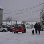 Juneau residents the streets in Douglas during a winter storm in December of 2021. (Peter Segall / Juneau Empire File)